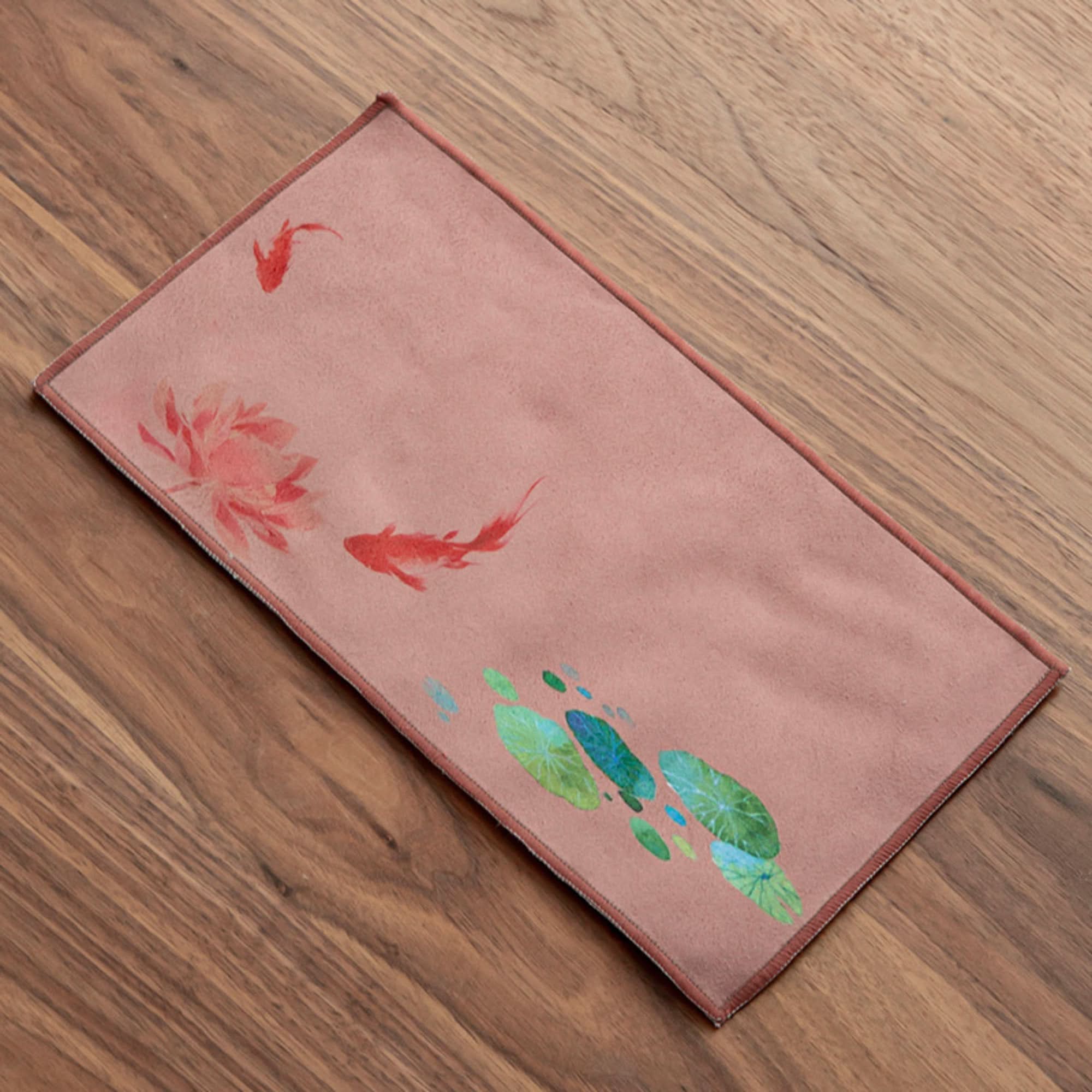 Ukiyo-e style Japanese tea towel with red koi fish and lotus flowers on a pink fabric.