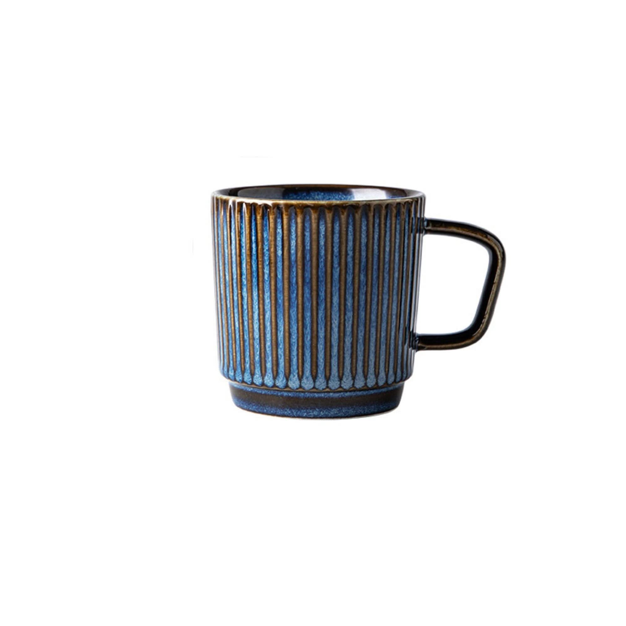 Blue glazed ceramic travel mug with vertical ridges, ideal for coffee or latte.