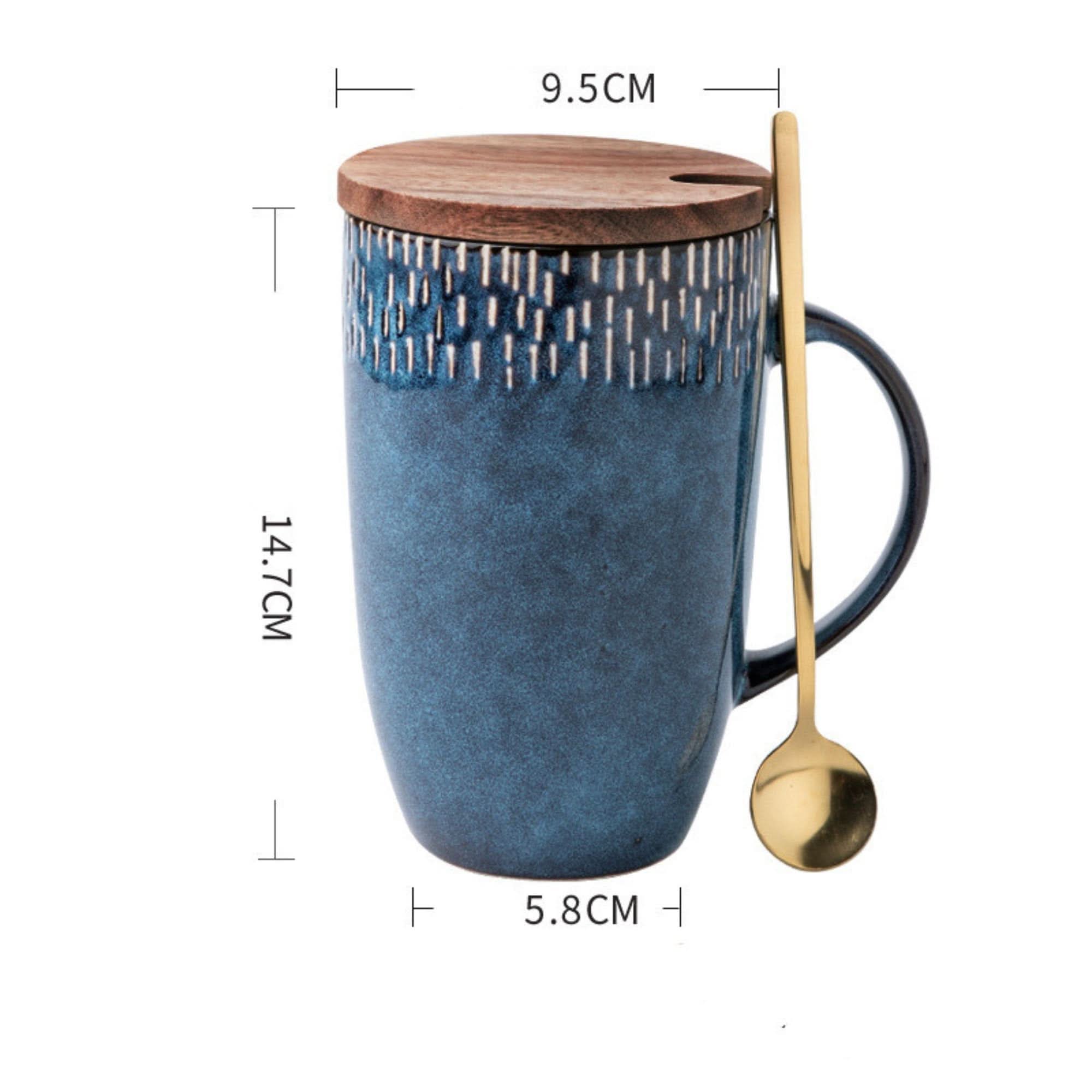 Blue glazed ceramic travel mug with wooden lid and gold spoon.