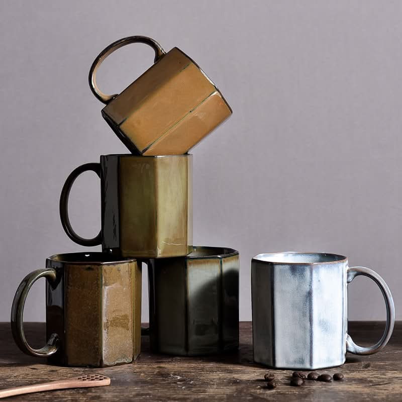 Nordic Rustic Hexagonal Ceramic Mugs: 5 rustic ceramic mugs in earthy tones on a wooden surface.