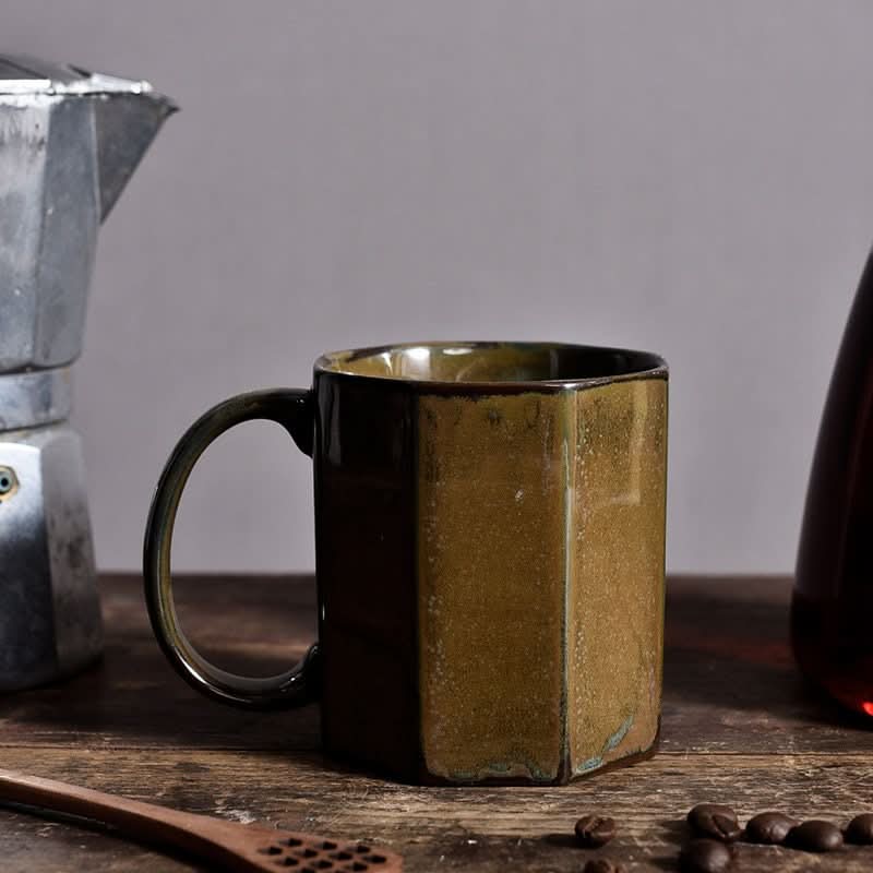 Nordic Rustic Hexagonal Ceramic Mug in earthy tones, set on a wooden surface with coffee beans.