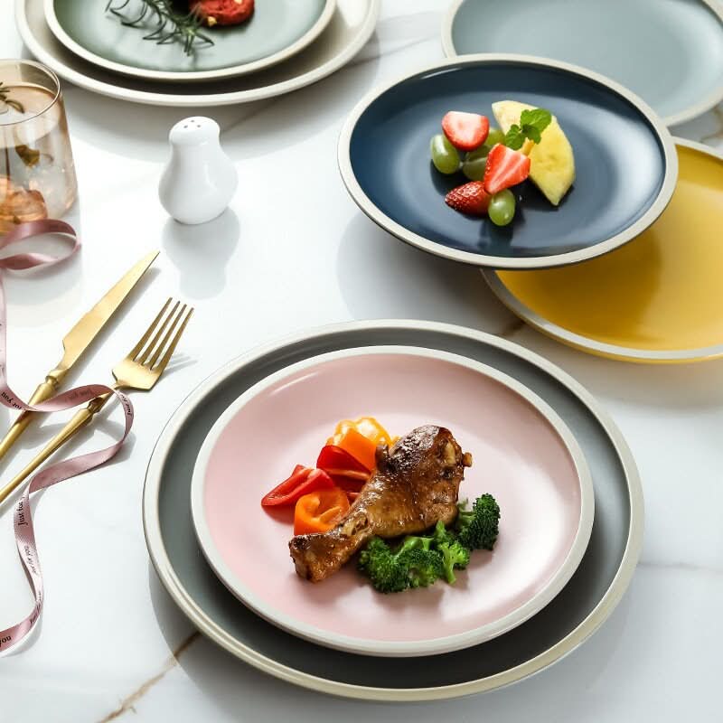 Ceramic Matt Plates with Scandinavian Colors, set with food, cutlery and drink.