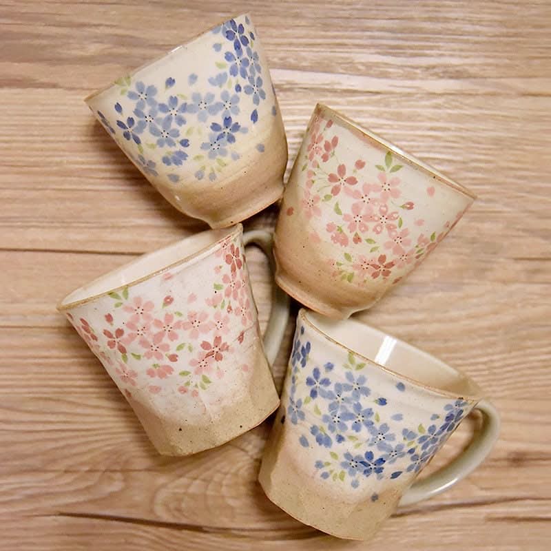 Japan Imported Stoneware Tea Cup Mugs: Handmade glazed cups with floral design on wood.