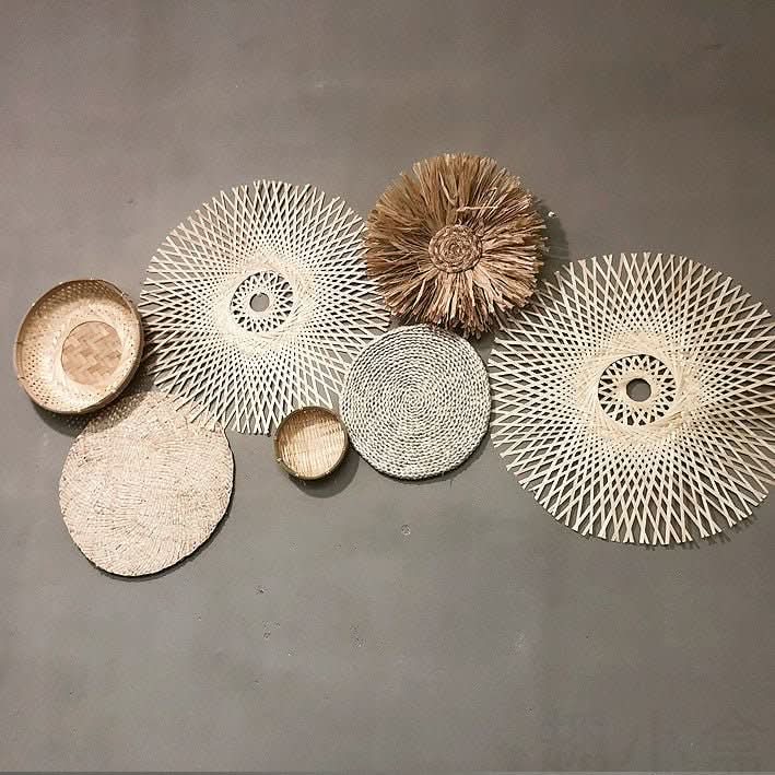 Boho rattan wall basket decor set with straw textures and natural materials on a gray wall.