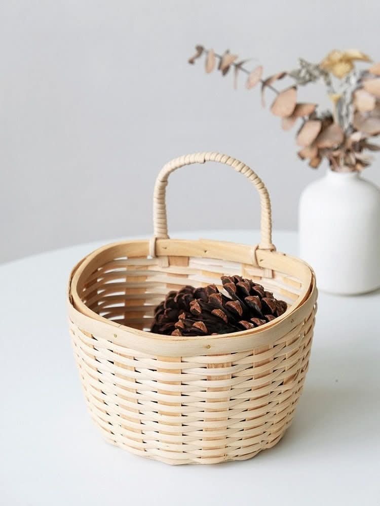 Rattan clear wood kitchen wall hanging basket filled with pinecones.
