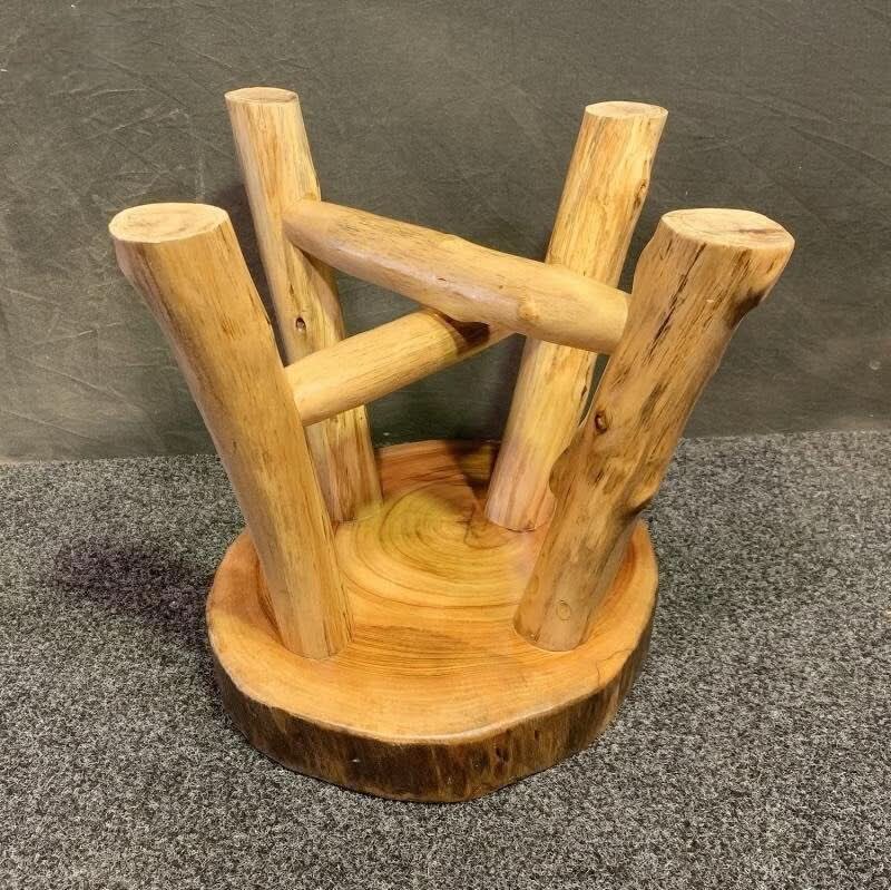 Natural wood Solid Wood Tree Ring Stool with visible rings and bark on a textured gray background.