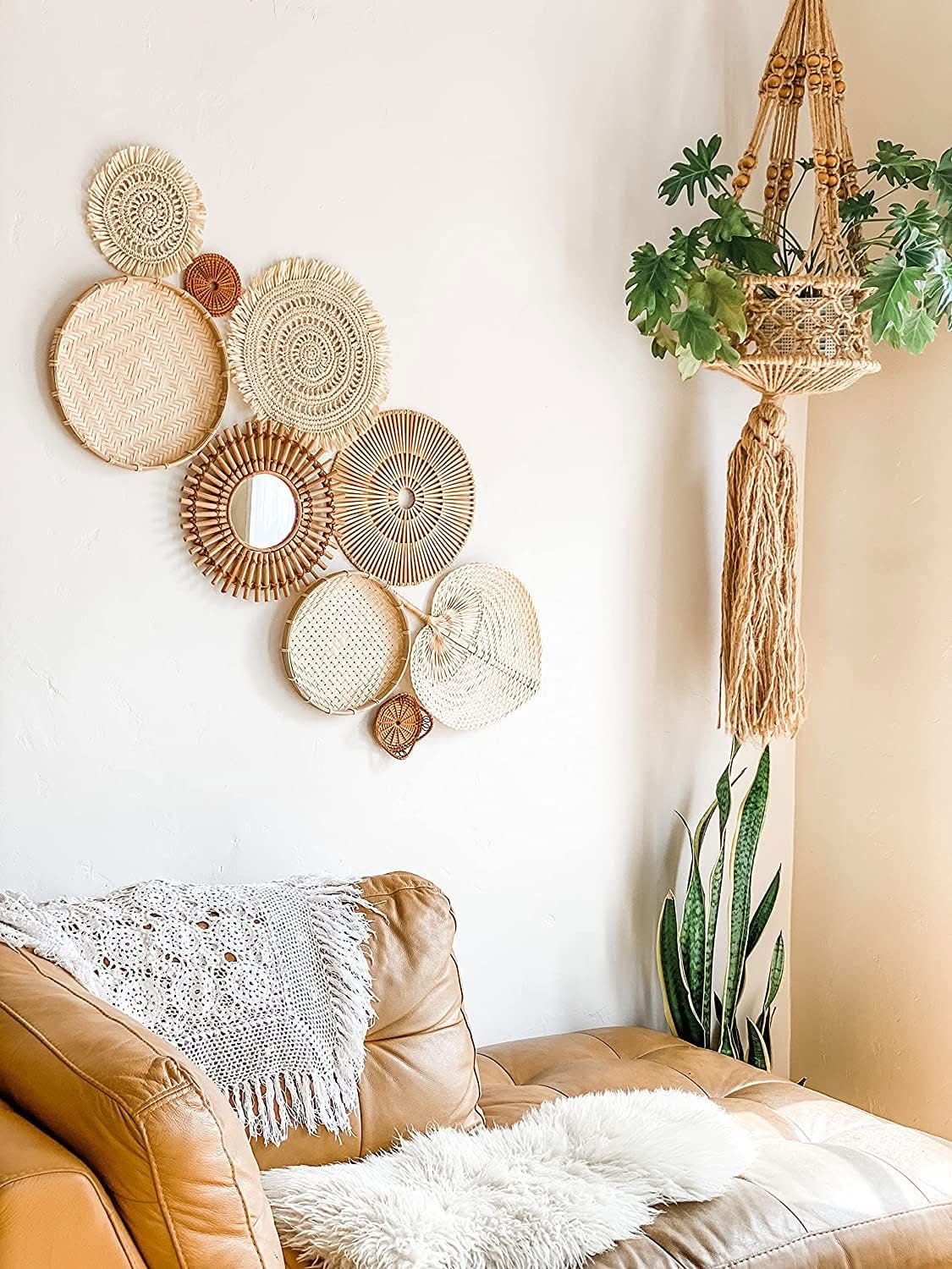 Handmade Straw Boho Wall Decoration: Round, natural straw wall art on white wall above leather sofa.