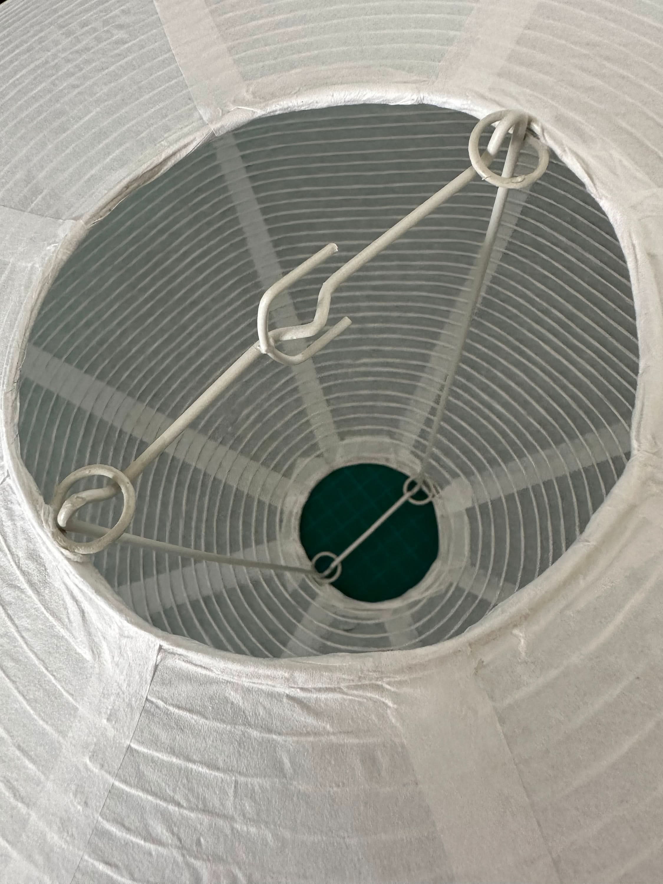 White paper lampshade with oval shape and metal frame, home decor accent.