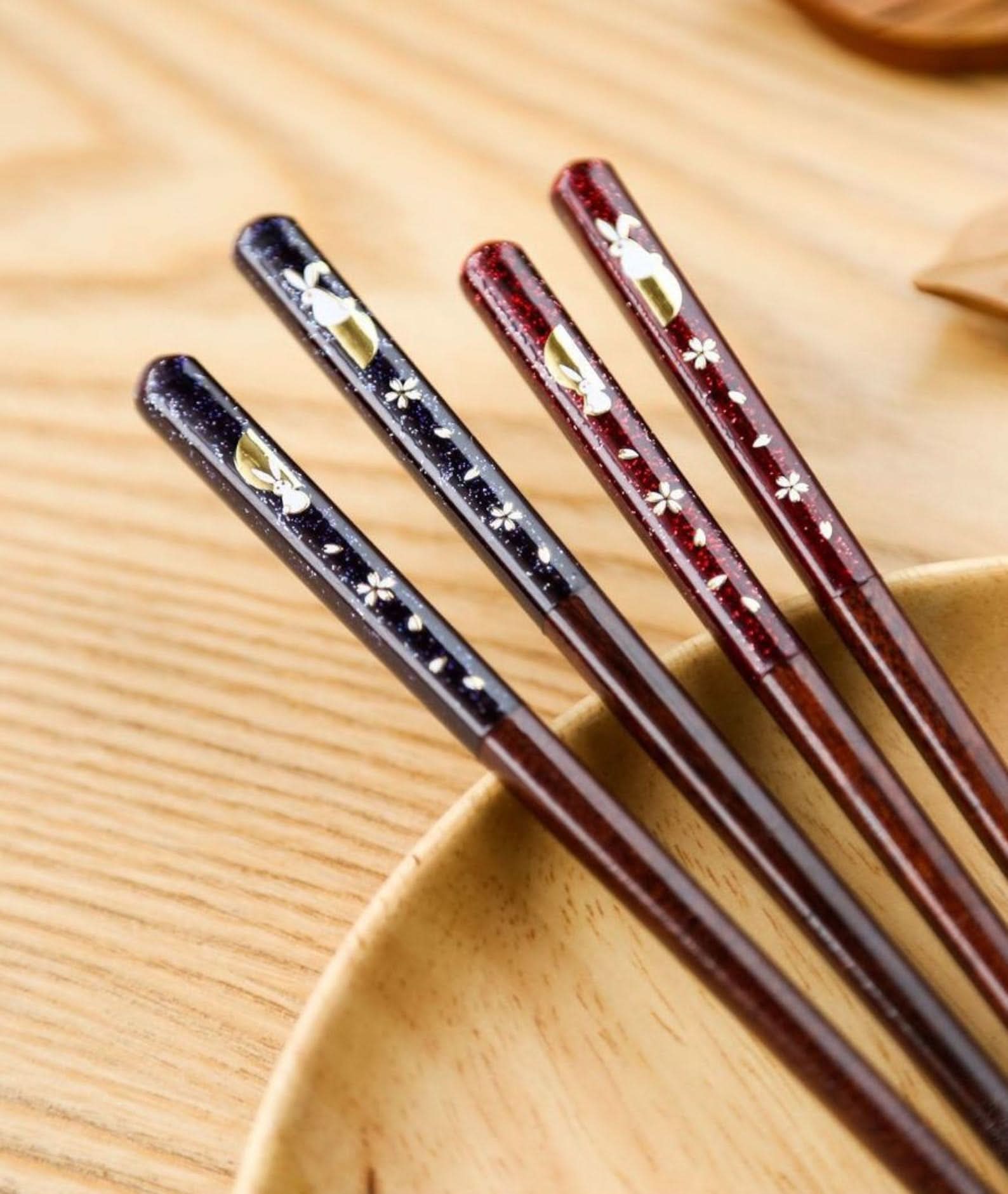 Imported Japanese Cherry Rabbit solid wood chopsticks, dark blue & red, with gold rabbits & cherry blossoms.