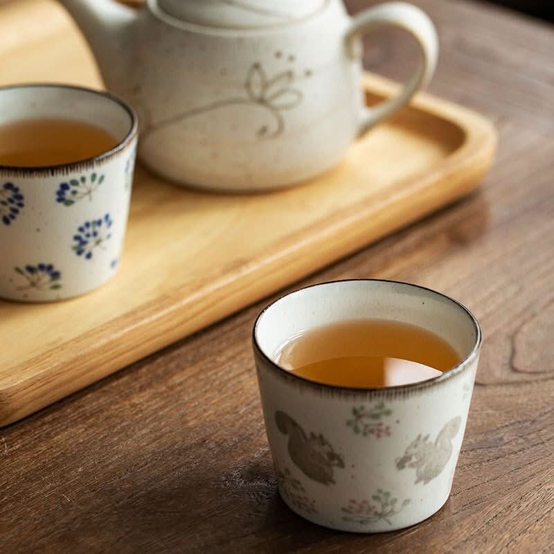 Japanese Mino-yaki Ceramic Hand-Held Cup 6.76oz with delicate squirrel pattern on wooden tray.