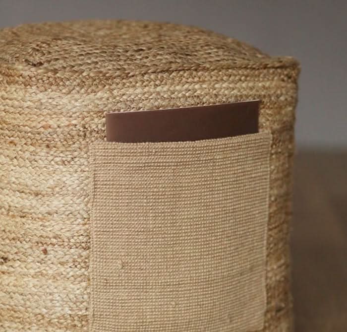 Close-up of Indian Hand-Woven Natural Jute Ottoman with brown pocket detail.