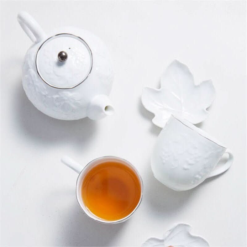 Irregular Wabi-Sabi Tea Set: White ceramic, grape engraved teapot, cup, & leaf saucers. Made in Japan.