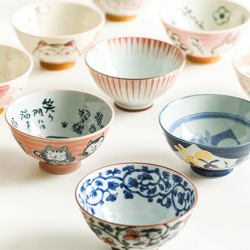 Japanese bowls with cat & floral illustrations in various colors and designs.