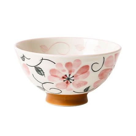 White ceramic Japanese bowl with pink floral illustrations and an orange base.