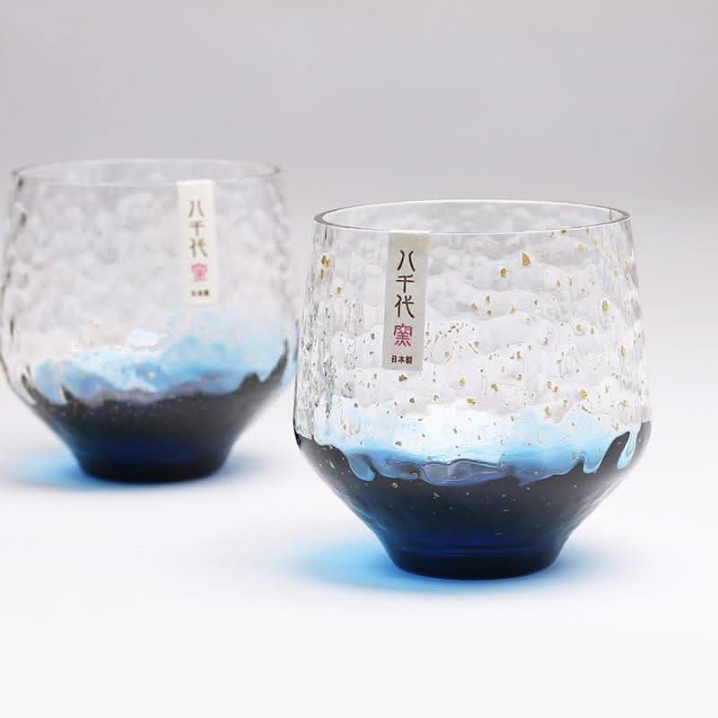 Japan imported hand-made colored glass cups with textured clear glass, gold flecks & blue/black gradient.