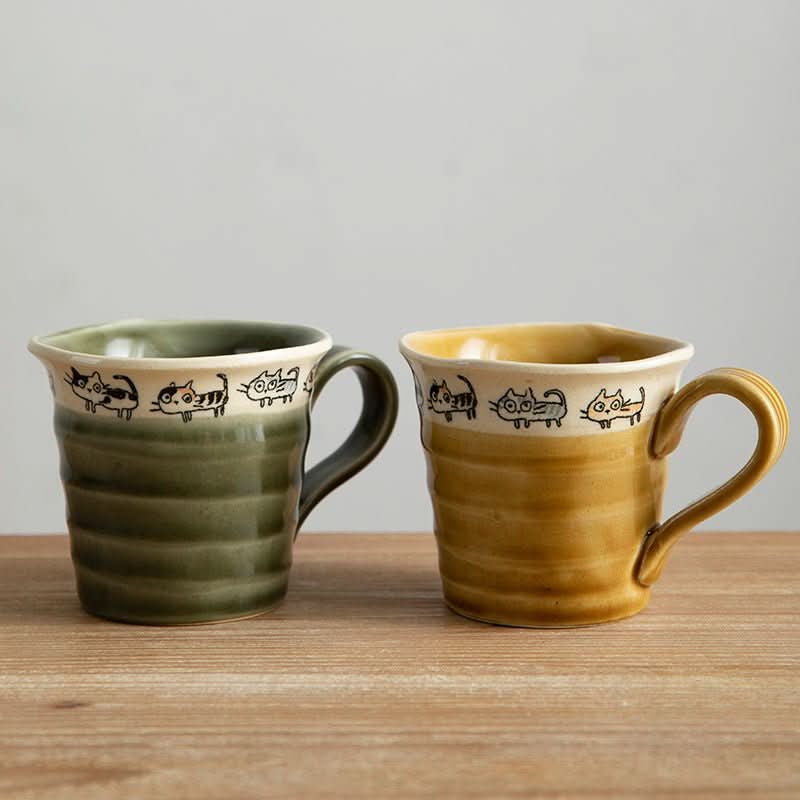 Japan imported hand made screw shaped cat mugs in green & yellow ceramic with charming cat print.
