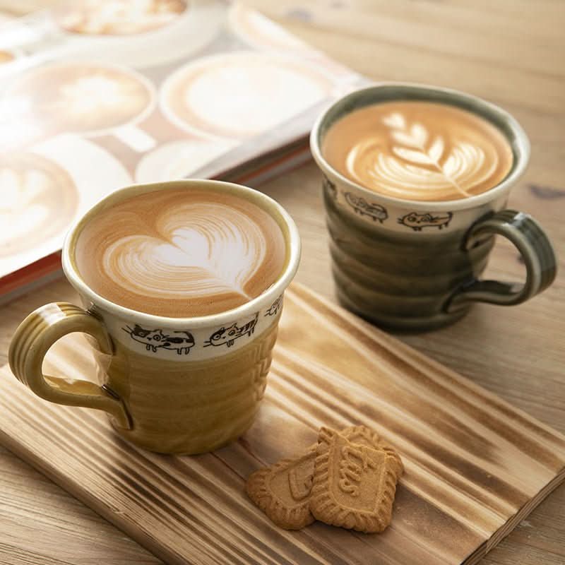 Japan imported Hand Made Screw Shaped Cat Mug with latte art and cookies.