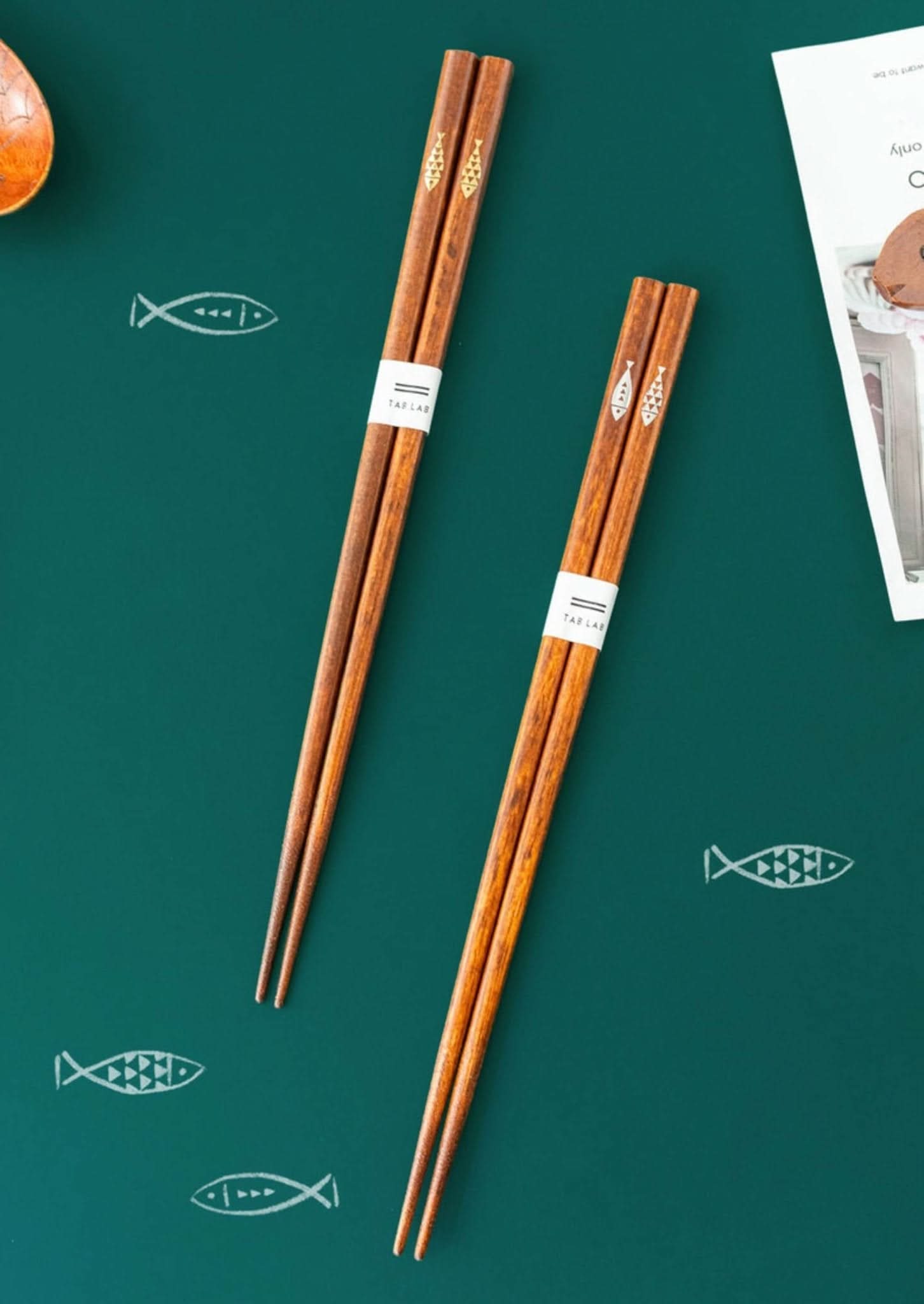 Japan Imported Handmade Wooden Chopsticks with cute fish detail on green background.