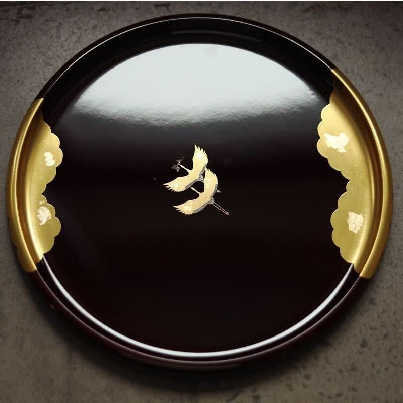 Japan Imported Kishu Lacquerware Tray: Round, gold cranes on dark, glossy surface with gold trim.