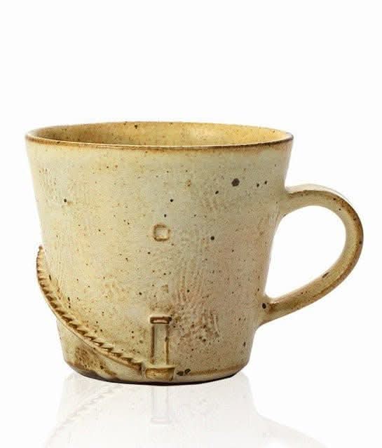 Japan Imported Lighthouse Mug: Handmade stoneware mug with textured detail.
