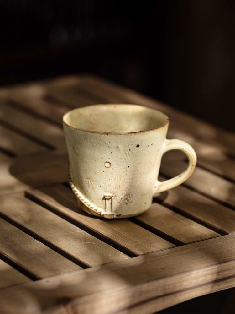 Japan imported lighthouse mug, handcrafted stoneware with a rustic speckled finish on a wooden surface.