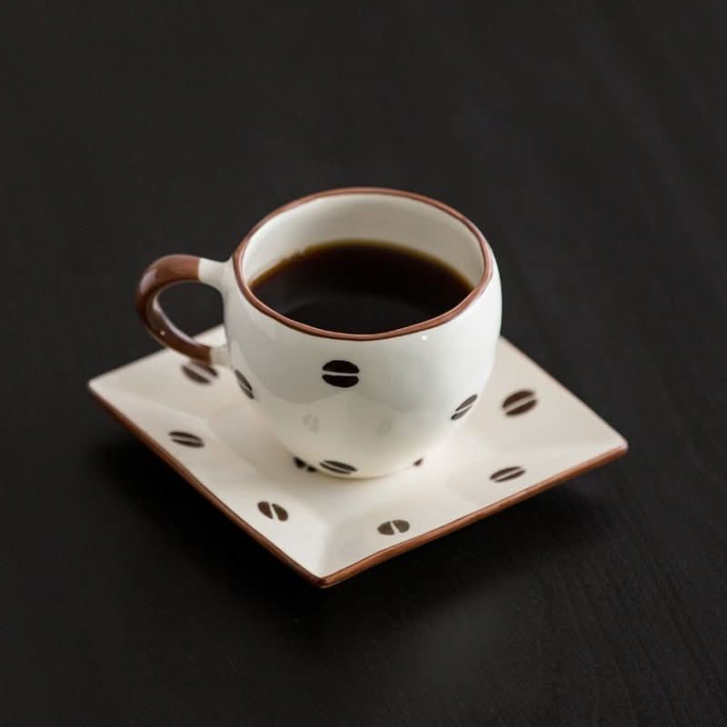 Japan Imported Mino Burn Ceramic Coffee Cup 8.45oz with coffee bean design on dark background.