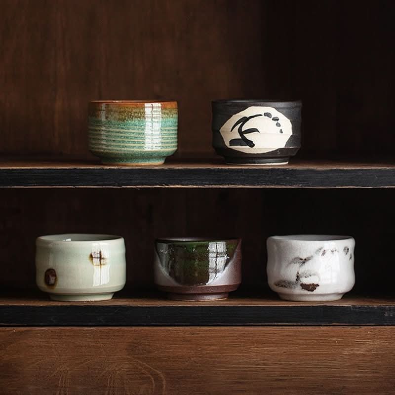 Mino-ware Evening Wind Japanese tea set: assorted ceramic cups with unique glazes on wooden shelves.