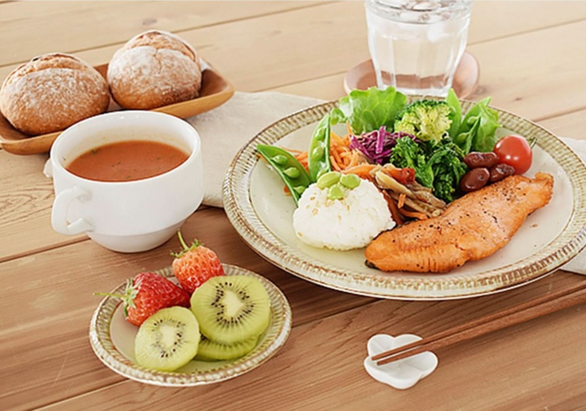 Japan imported Mino Ware Beige Dish Set showcases a rustic meal with salmon, rice, salad, soup, bread, and fruit.