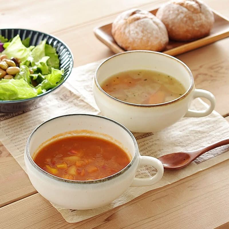 White ceramic Mino-Yaki single handle bowl with soup and salad.