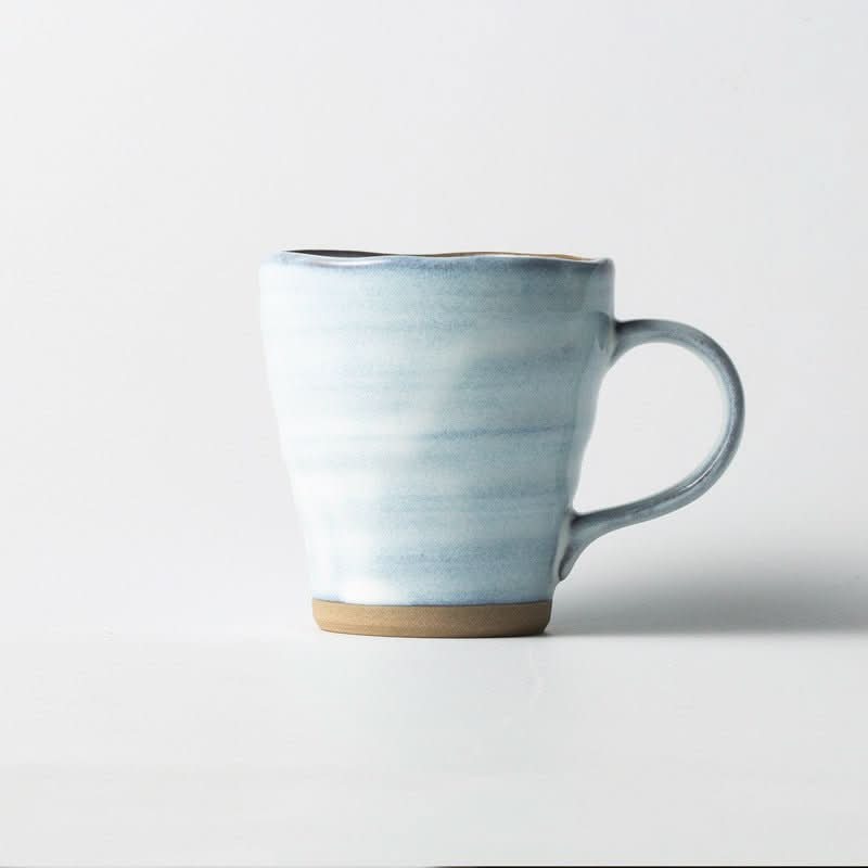 Japan Imported Minoyaki ceramic mug with underglaze blue and white finish, earthy base.