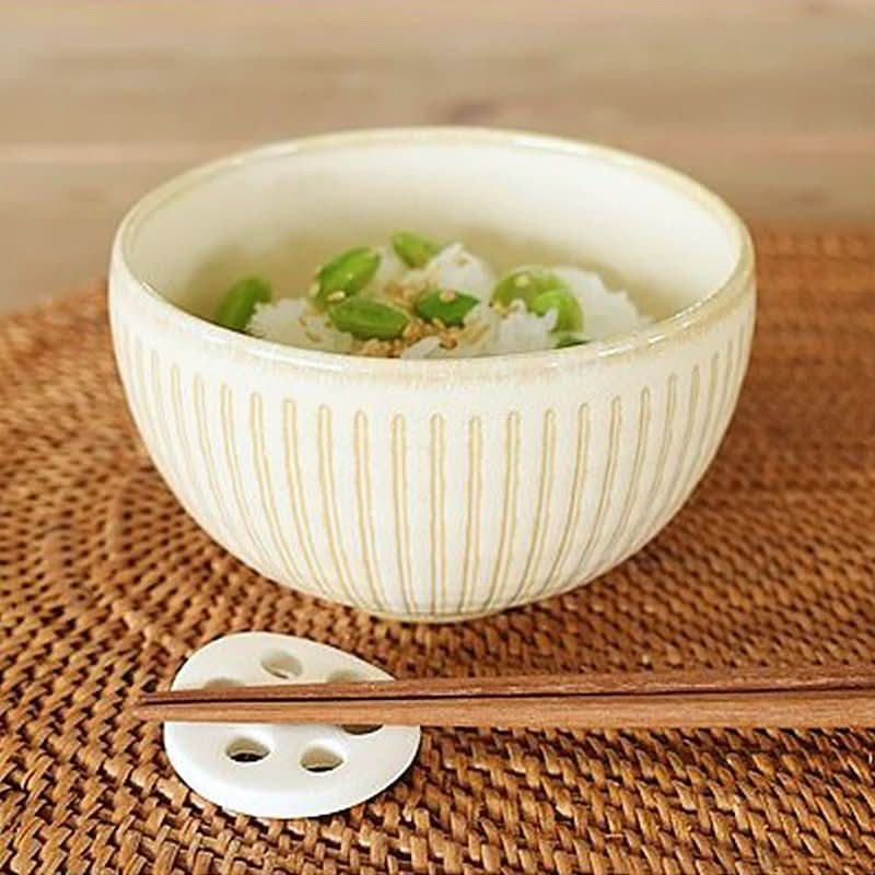 Cream Japanese ceramic bowl with vertical ridges, filled with rice & edamame. Home decor.