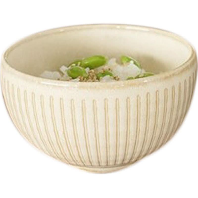 Cream Japanese ceramic bowl with ribbed texture, filled with rice, edamame, and sesame seeds.