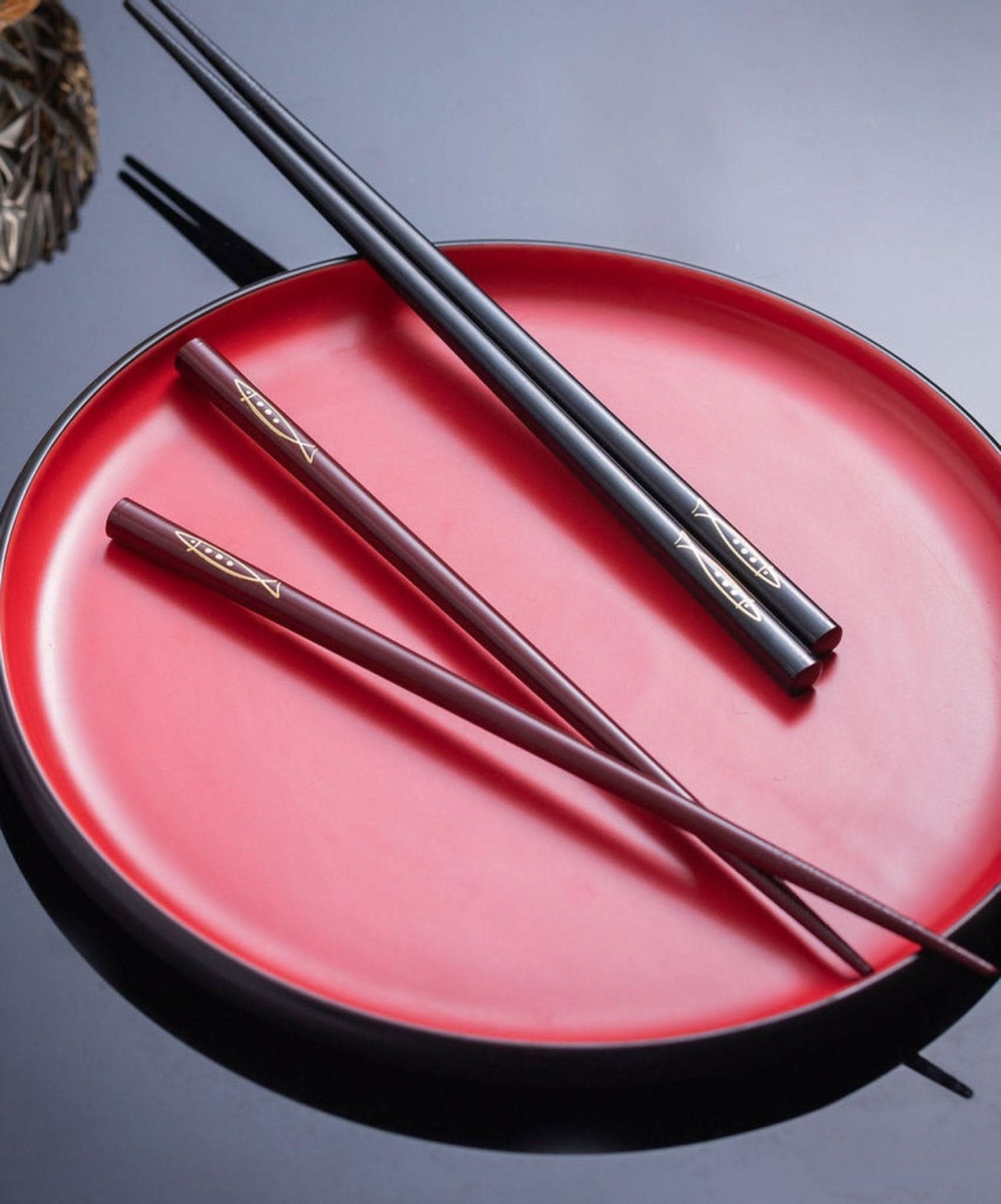 Japan Imported Non-Slip Koi Fish Wooden Chopsticks set on a red tray.
