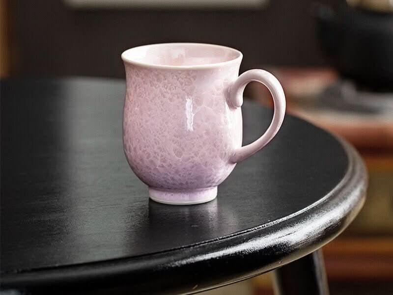 Japan Imported Pottery Mug, light pink crystal glaze ceramic water cup on black table.