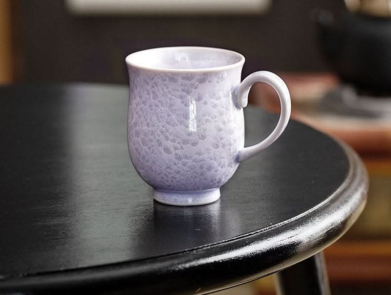 Japan Imported Pottery: light purple crystal glaze mug with unique texture on dark wood table.