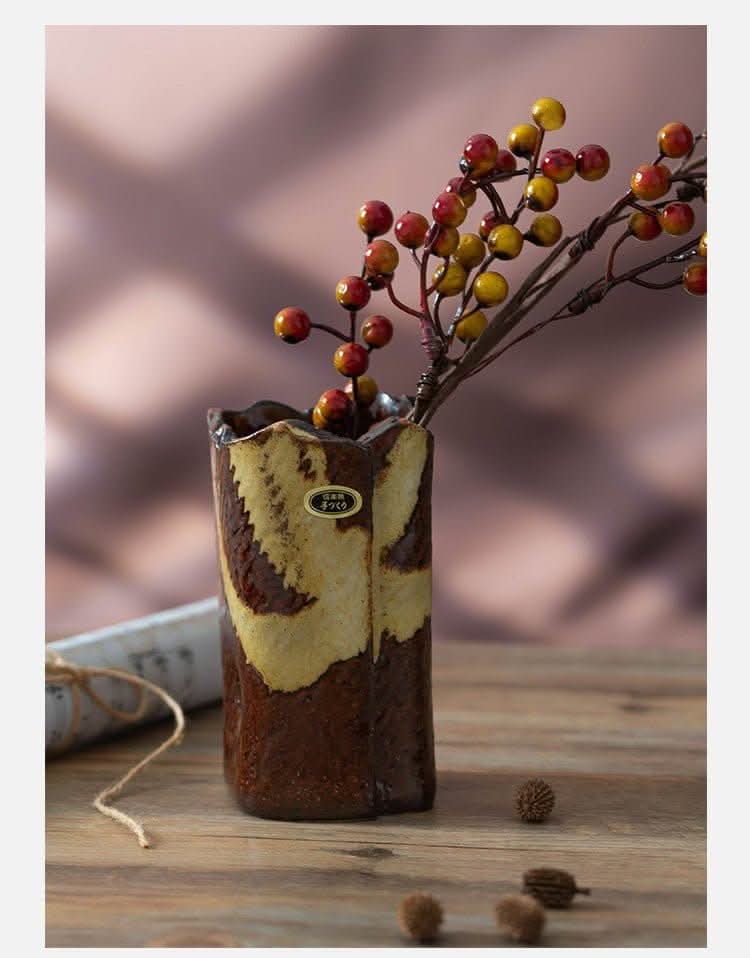 Japan imported stoneware pottery vase ornament with berry branches on rustic wood.