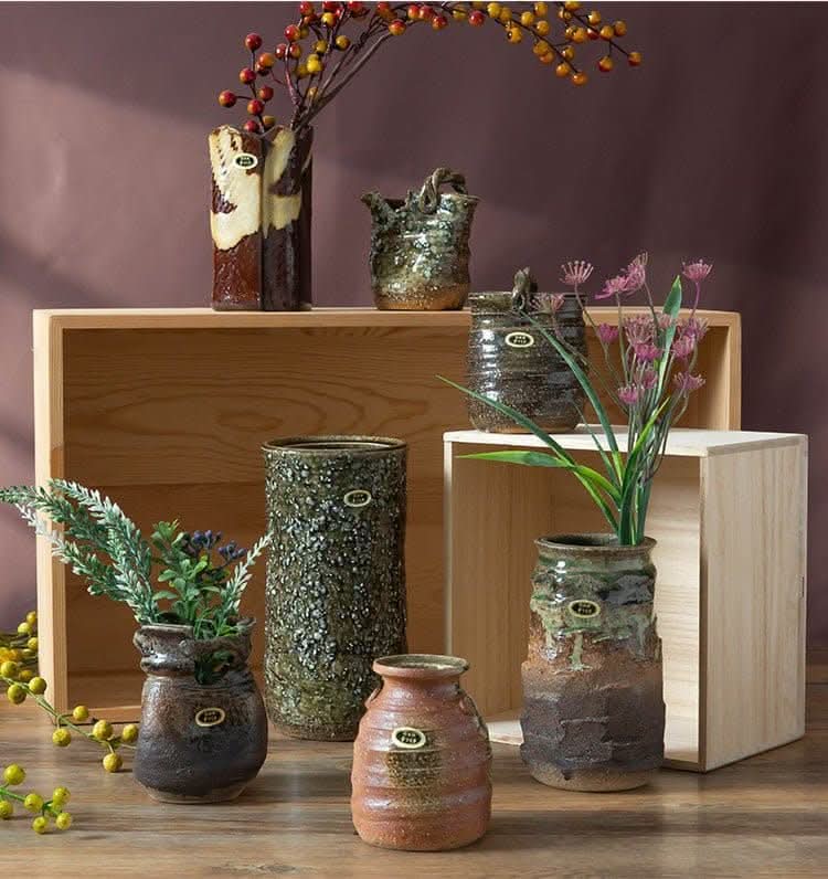 Japan imported stoneware pottery vase ornaments: assorted textured ceramic vases with subtle floral and greenery accents.
