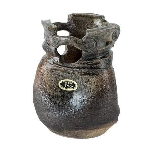 Japan imported stoneware pottery vase ornament with textured finish and unique openings.