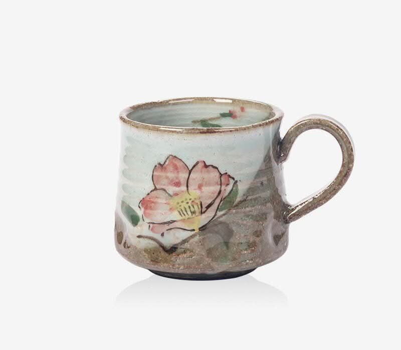 Seto-yaki ceramic mug with flower design in blue, pink, and brown hues. Home decor.