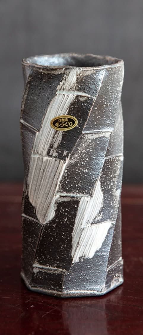 Japan imported Shigaraki ceramic flower arrangement with textured black and white glaze.
