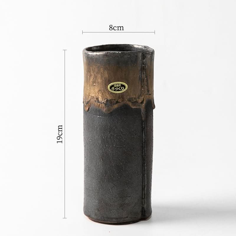 Japan imported Shigaraki ceramic flower arrangement, 19cm tall, 8cm wide, textured black and bronze glaze.