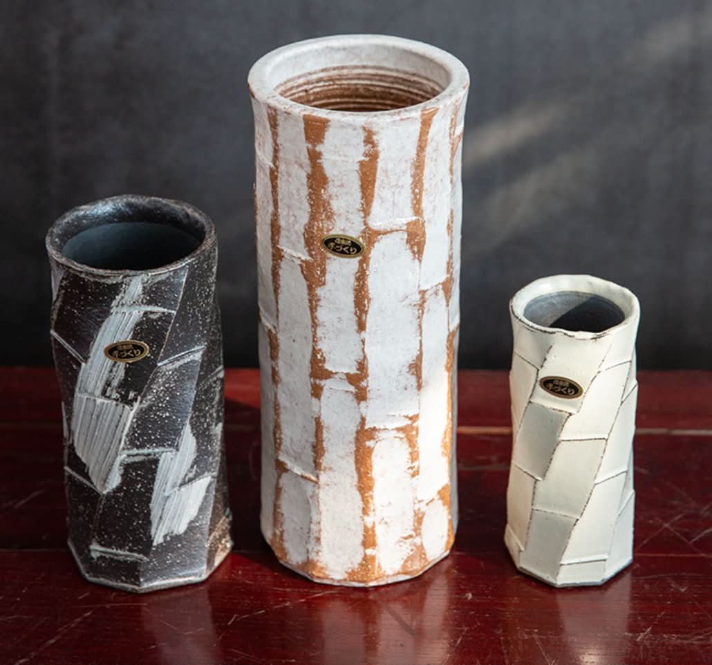 Japan imported Shigaraki ceramic flower arrangement vases in black, white, and cream with textured surfaces.