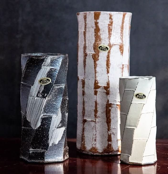 Japan imported Shigaraki ceramic flower arrangement in black, white, and earth tones.