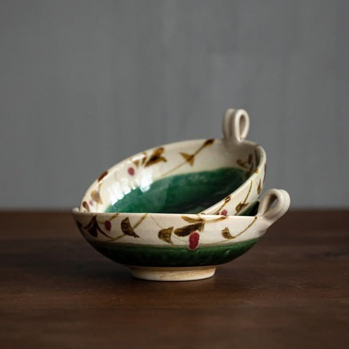 Hand-painted Japanese bowl, green glaze, brown floral design, handle.