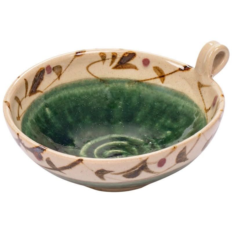 Hand-painted Japanese ceramic bowl with handle, featuring a green glaze and floral motif.