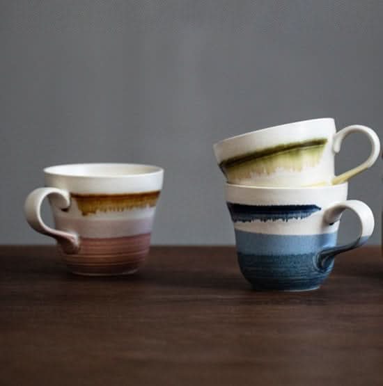 Stove Master Kiln Shore Cup: Ceramic mugs in pink, brown, blue, and green hues.