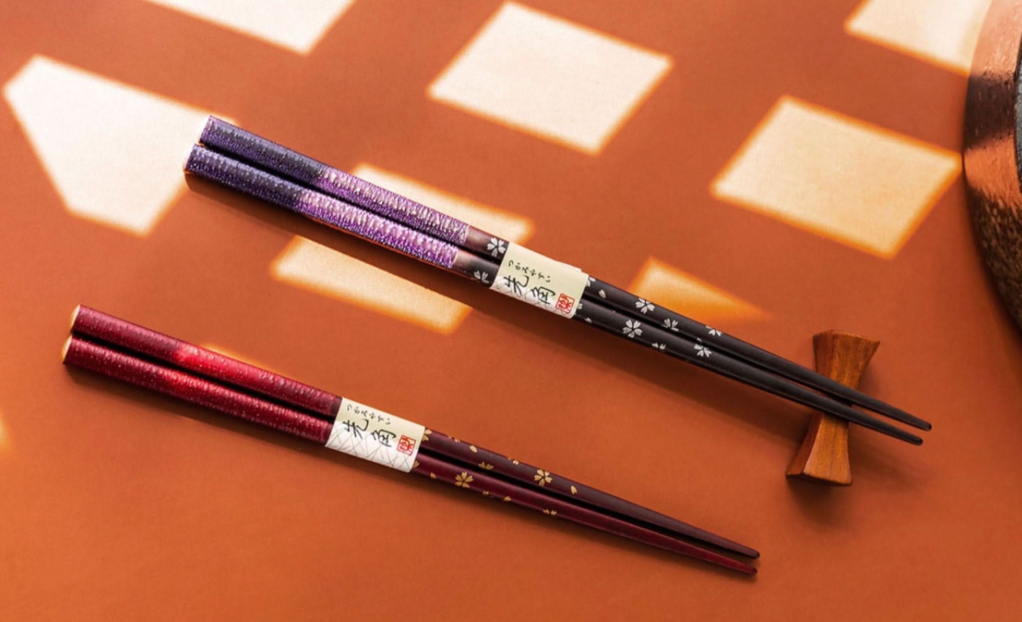 Japan Imported Sunlife Cherry Chopsticks in deep red & purple, with wood chopstick rest.