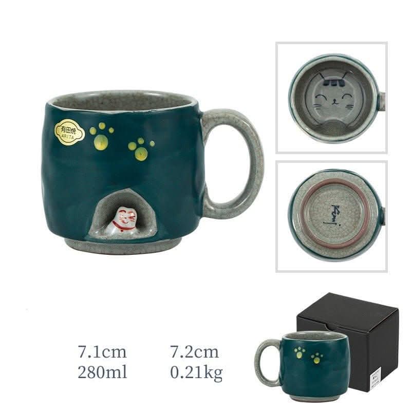 Japan imports Arita ware hand-made cat mug, featuring a small cat in a cutout, paw prints, and a dark green glaze.