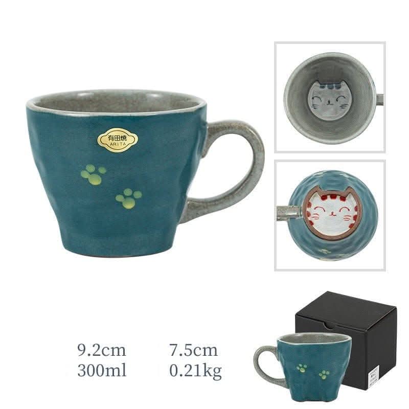 Japan imports Arita ware hand-made teal cat mug with paw prints. Cat face inside.