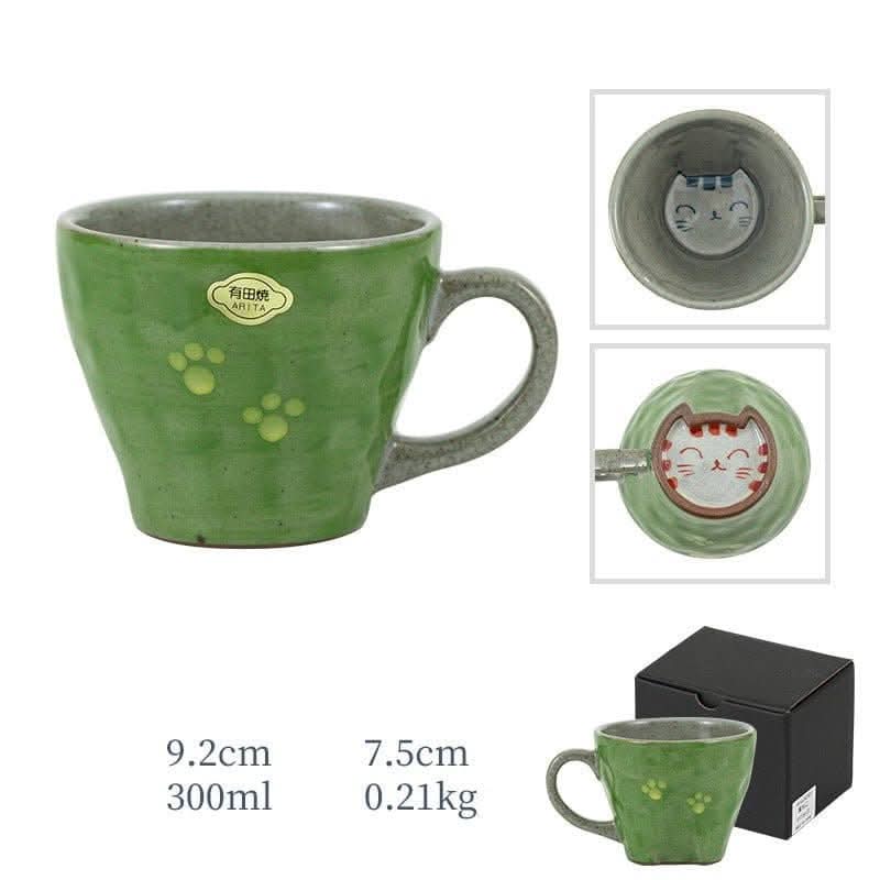 Japan imports Arita ware hand-made cat mug in green with paw prints and cute cat design.